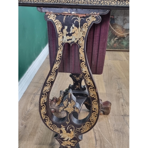 306 - A 19th Century chinoiserie ebonised and gilt Sewing/Work Table decorated figures and temples in a la... 