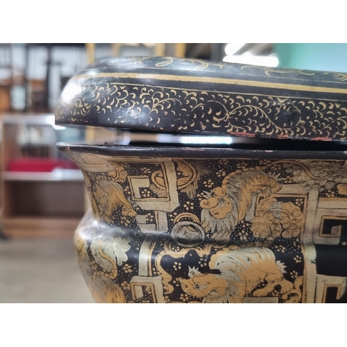 306 - A 19th Century chinoiserie ebonised and gilt Sewing/Work Table decorated figures and temples in a la... 