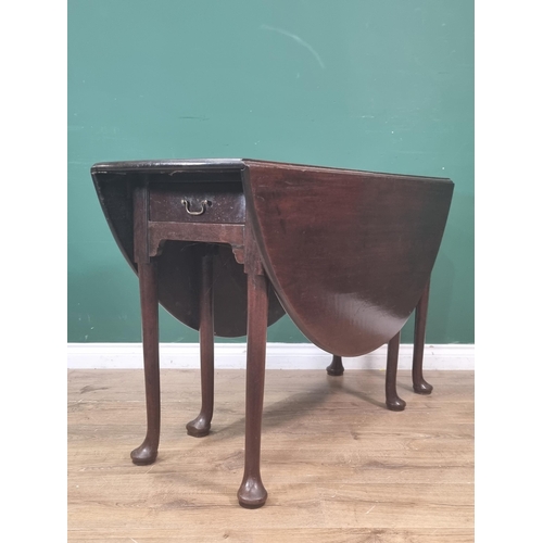 307 - A Georgian cuban mahogany Dropleaf Table with oval top, fitted frieze drawer on turned supports and ... 