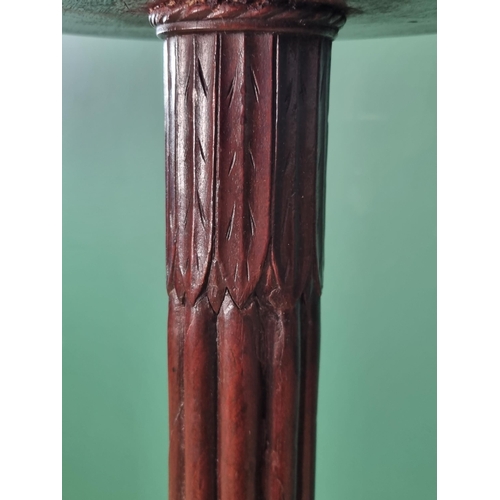 308 - A pair of mahogany Torcheres with reeded baluster column and carved tripod bases, 4ft 10 1/2in H