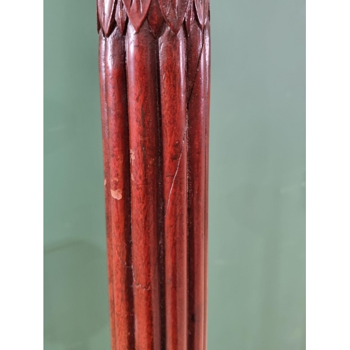 308 - A pair of mahogany Torcheres with reeded baluster column and carved tripod bases, 4ft 10 1/2in H