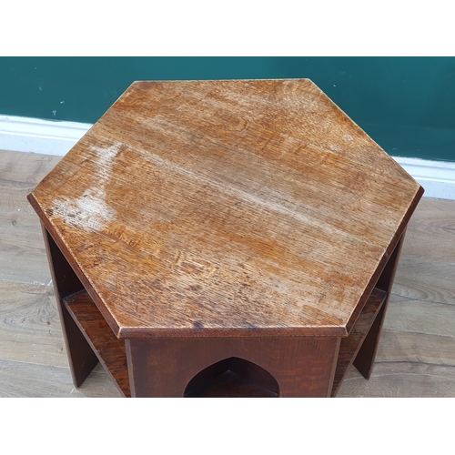 309 - An Arts and Crafts style oak Book Table in the manner of Liberty & Co, with hexagonal top above thre... 