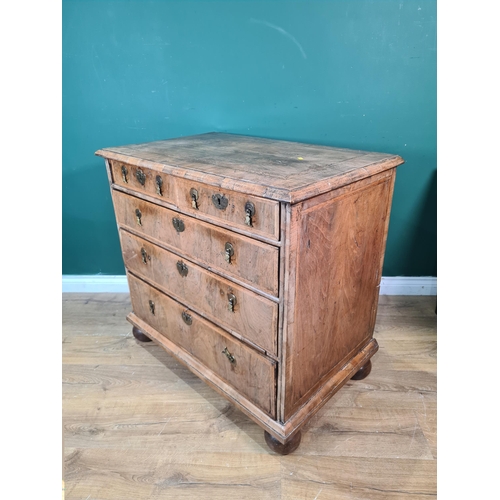 312 - An 18th Century Chest of two short above three long graduated drawers with moulded quartered veneere... 