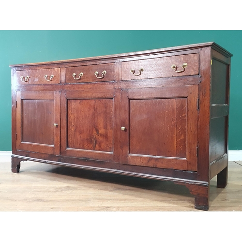 319 - An antique oak Dresser Base fitted three drawers above a pair of cupboards doors, 5ft 2in W