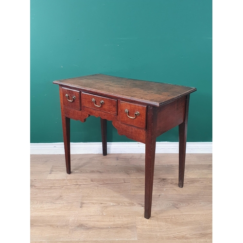 324 - A late 18th Century oak Lowboy with moulded top and fitted three drawers around a shaped frieze on c... 