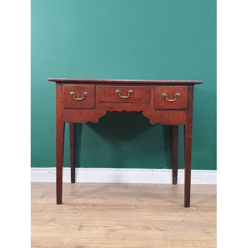 324 - A late 18th Century oak Lowboy with moulded top and fitted three drawers around a shaped frieze on c... 