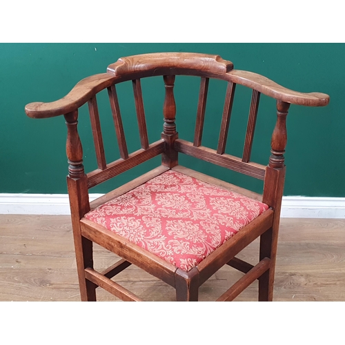 325 - An early 19th Century fruitwood Corner Elbow Chair with reeded bar back, drop in seat on squared sup... 