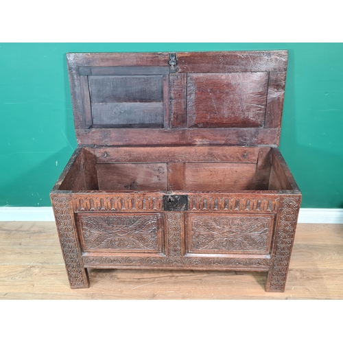 340 - A 17th Century joined oak Coffer with sunken two panel lid above nulled frieze and carved two panel ... 