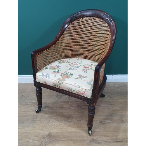 342 - A 19th Century mahogany framed caned Bergere Armchair, with carved floral rosette decorations, with ... 