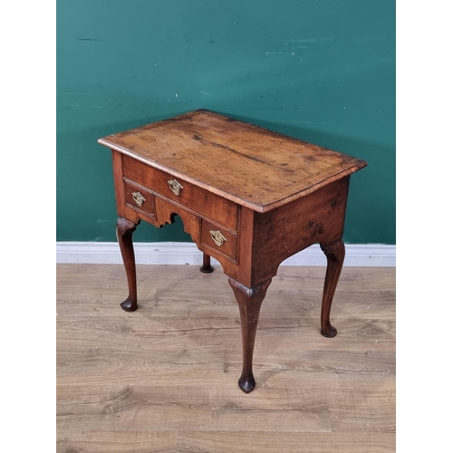 347 - An 18th Century walnut Lowboy, with feather and crossbanded top above three drawers and shaped friez... 