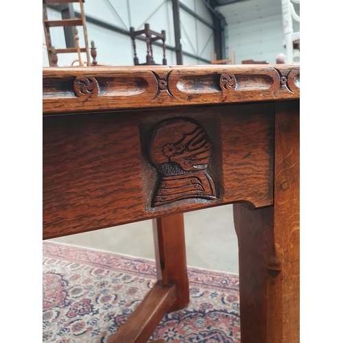 348 - A Knightsman style oak Refectory Table with carved edge, carving to the frieze Knight's head, etc, o... 