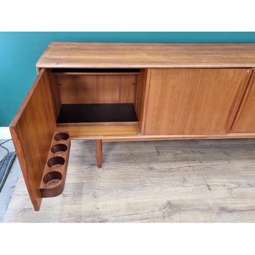 349 - A mid-century Danish teak Sideboard fitted three cupboard doors and four drawers on turned supports ... 