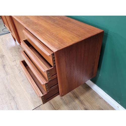 349 - A mid-century Danish teak Sideboard fitted three cupboard doors and four drawers on turned supports ... 