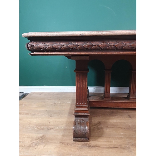 354 - A mahogany Library Table with inset writing surface, leafage carved frieze and raised on Renaissance... 