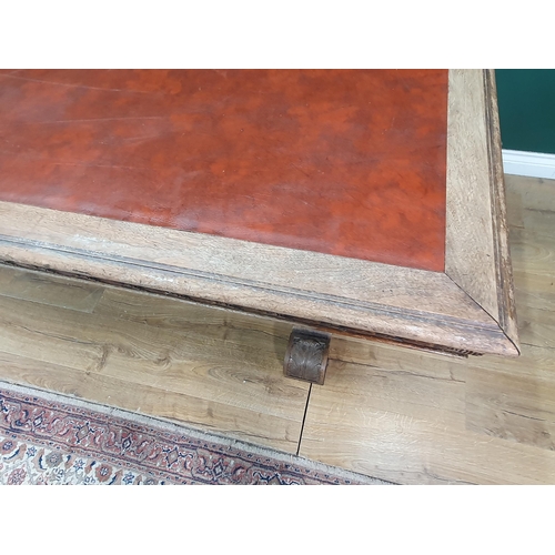 354 - A mahogany Library Table with inset writing surface, leafage carved frieze and raised on Renaissance... 