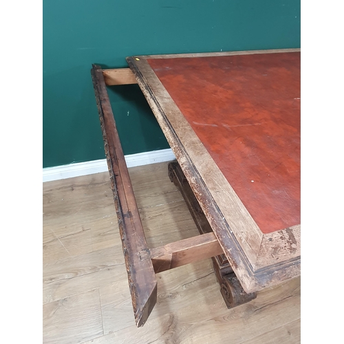 354 - A mahogany Library Table with inset writing surface, leafage carved frieze and raised on Renaissance... 