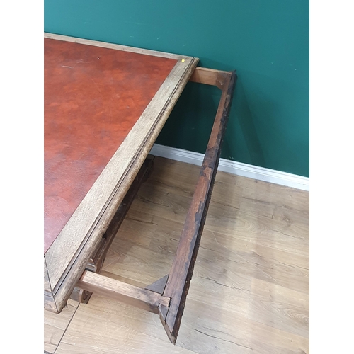 354 - A mahogany Library Table with inset writing surface, leafage carved frieze and raised on Renaissance... 