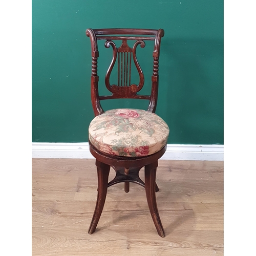 358 - A Regency simulated rosewood revolving Music Chair with lyre back, upholstered seat on four splayed ... 