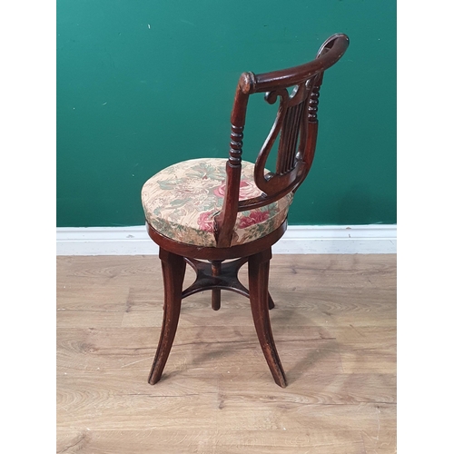 358 - A Regency simulated rosewood revolving Music Chair with lyre back, upholstered seat on four splayed ... 