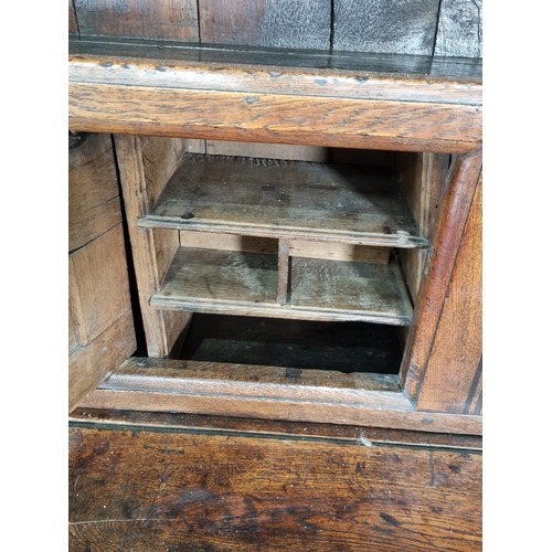 365 - An 18th Century oak enclosed Dresser with rack fitted three fielded panel doors above base fitted tw... 