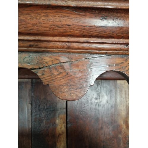 365 - An 18th Century oak enclosed Dresser with rack fitted three fielded panel doors above base fitted tw... 