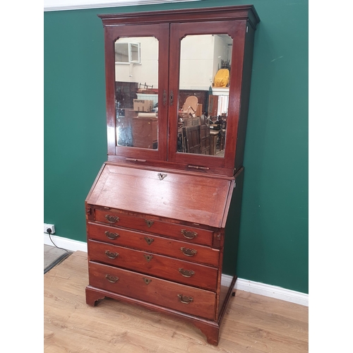 372 - A Georgian mahogany Bureau Bookcase, the upper section with mirror panelled doors, enclosing adjusta... 