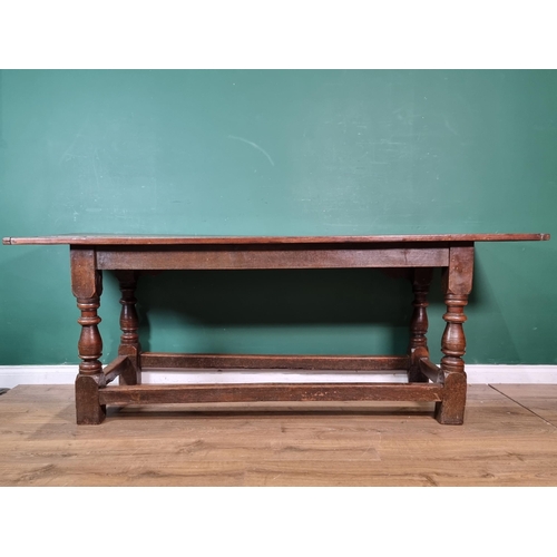 382 - A 17th Century oak Refectory Table with cleated three plank top above leafage arcade carved frieze r... 