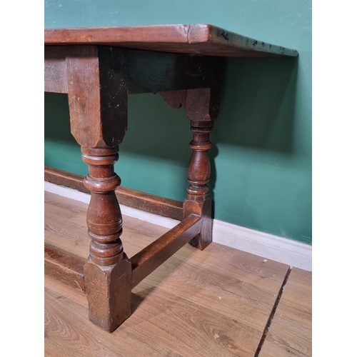 382 - A 17th Century oak Refectory Table with cleated three plank top above leafage arcade carved frieze r... 