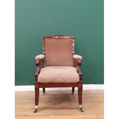 384 - A 19th Century mahogany framed Open Armchair, with carved scrolled top rail, sloping cane-work backr... 