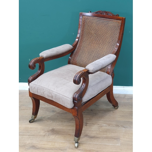 384 - A 19th Century mahogany framed Open Armchair, with carved scrolled top rail, sloping cane-work backr... 