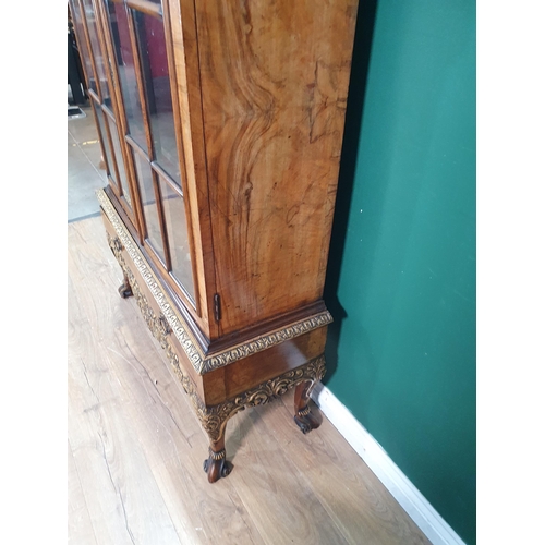 385 - A Queen Anne style carved walnut and gilt Cabinet on stand, the moulded cornice above and pair of gl... 