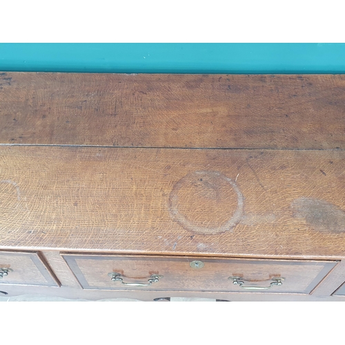 386 - A Georgian oak and crossbanded Dresser Base, fitted three drawers above a shaped frieze on squared s... 