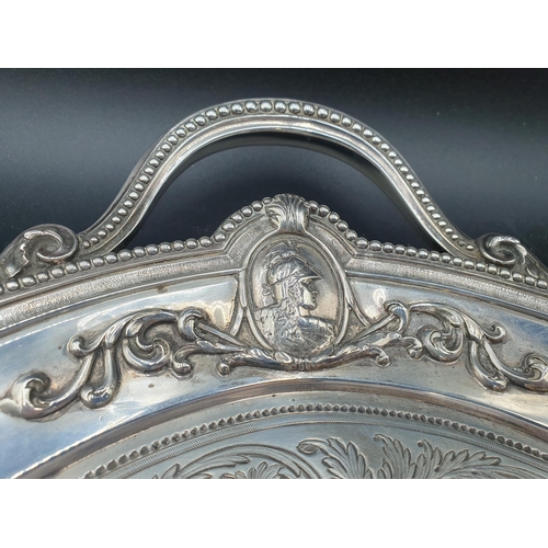 39 - A Victorian silver two handled oval Tea Tray with leafage scroll engraving, four portrait medallions... 