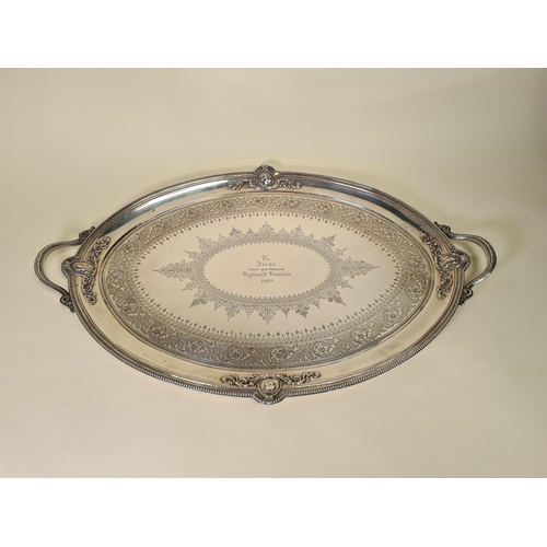 39 - A Victorian silver two handled oval Tea Tray with leafage scroll engraving, four portrait medallions... 