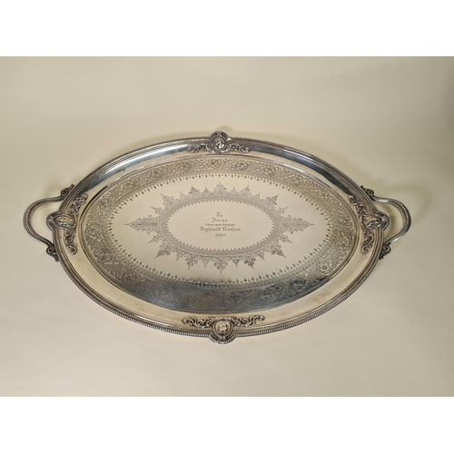 39 - A Victorian silver two handled oval Tea Tray with leafage scroll engraving, four portrait medallions... 