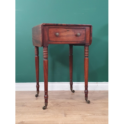 393 - A Regency mahogany Work Table with drop leaves fitted frieze drawer on ring turned supports and cast... 