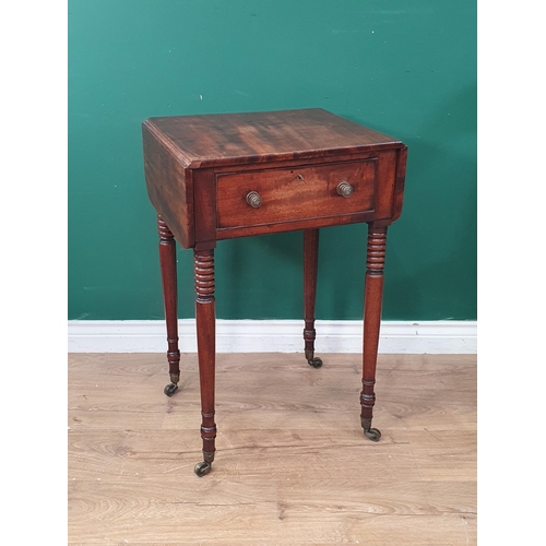 393 - A Regency mahogany Work Table with drop leaves fitted frieze drawer on ring turned supports and cast... 