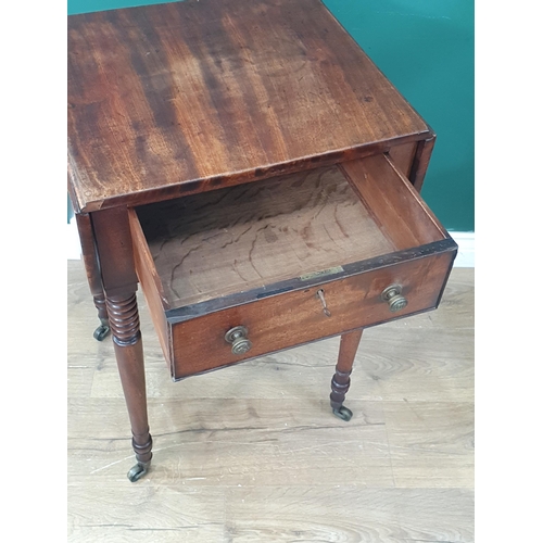 393 - A Regency mahogany Work Table with drop leaves fitted frieze drawer on ring turned supports and cast... 