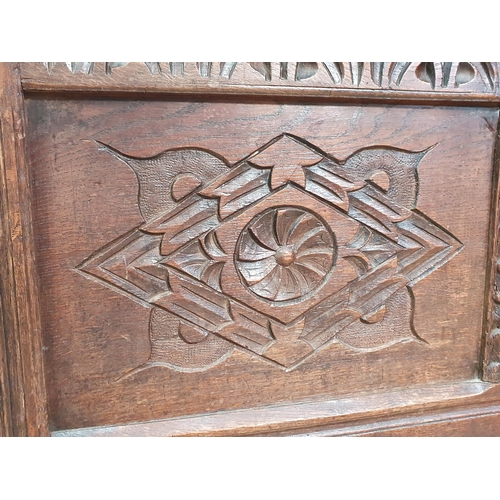 400 - A late 17th Century oak Coffer, with sunken three panel lid, above carved arched floral frieze, and ... 