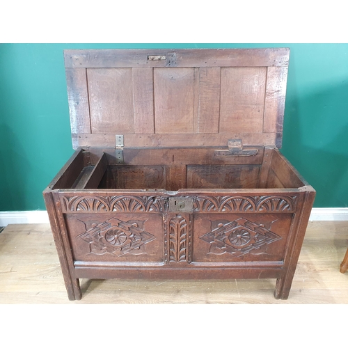 400 - A late 17th Century oak Coffer, with sunken three panel lid, above carved arched floral frieze, and ... 