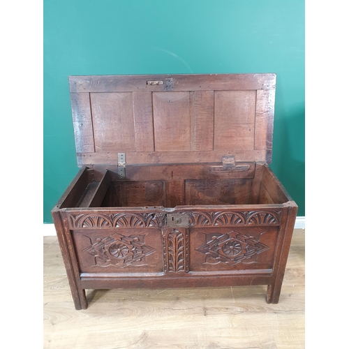 400 - A late 17th Century oak Coffer, with sunken three panel lid, above carved arched floral frieze, and ... 