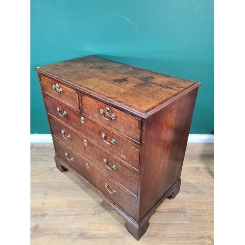 411 - A late Georgian oak Chest with cross-banded top above two short and three long drawers on bracket fe... 