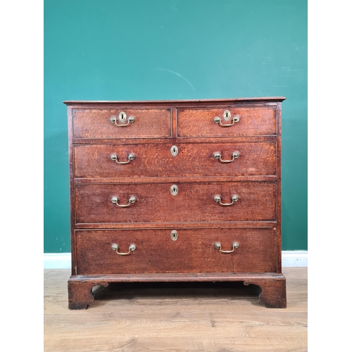 411 - A late Georgian oak Chest with cross-banded top above two short and three long drawers on bracket fe... 