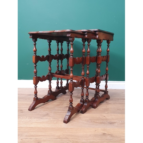 422 - A Burr Walnut Nest of three Tables, with moulded rectangular tops, on turned spindle supports united... 