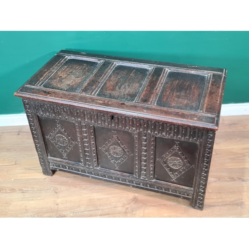 424 - A 17th Century oak Coffer with panelled top, lozenge carved front and with original hinges, 3ft 7in ... 