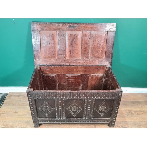 424 - A 17th Century oak Coffer with panelled top, lozenge carved front and with original hinges, 3ft 7in ... 