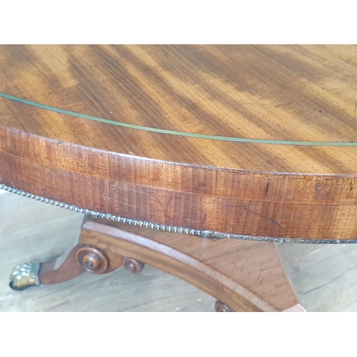 428 - A Regency mahogany circular Centre Table with brass inlaid top on turned and fluted column, concave ... 