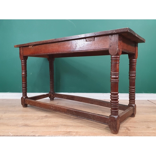 434 - A 17th Century Oak Serving Table with three plank top, raised on ring turned supports, united by str... 