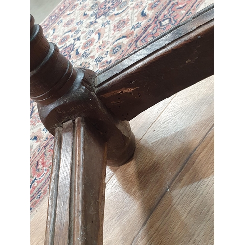 434 - A 17th Century Oak Serving Table with three plank top, raised on ring turned supports, united by str... 