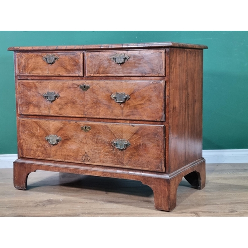 436 - An 18th Century walnut Chest of two short and two long drawers with moulded top raised on bracket fe... 